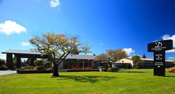 Distinction Hotel Te Anau exterior with lawns and signage